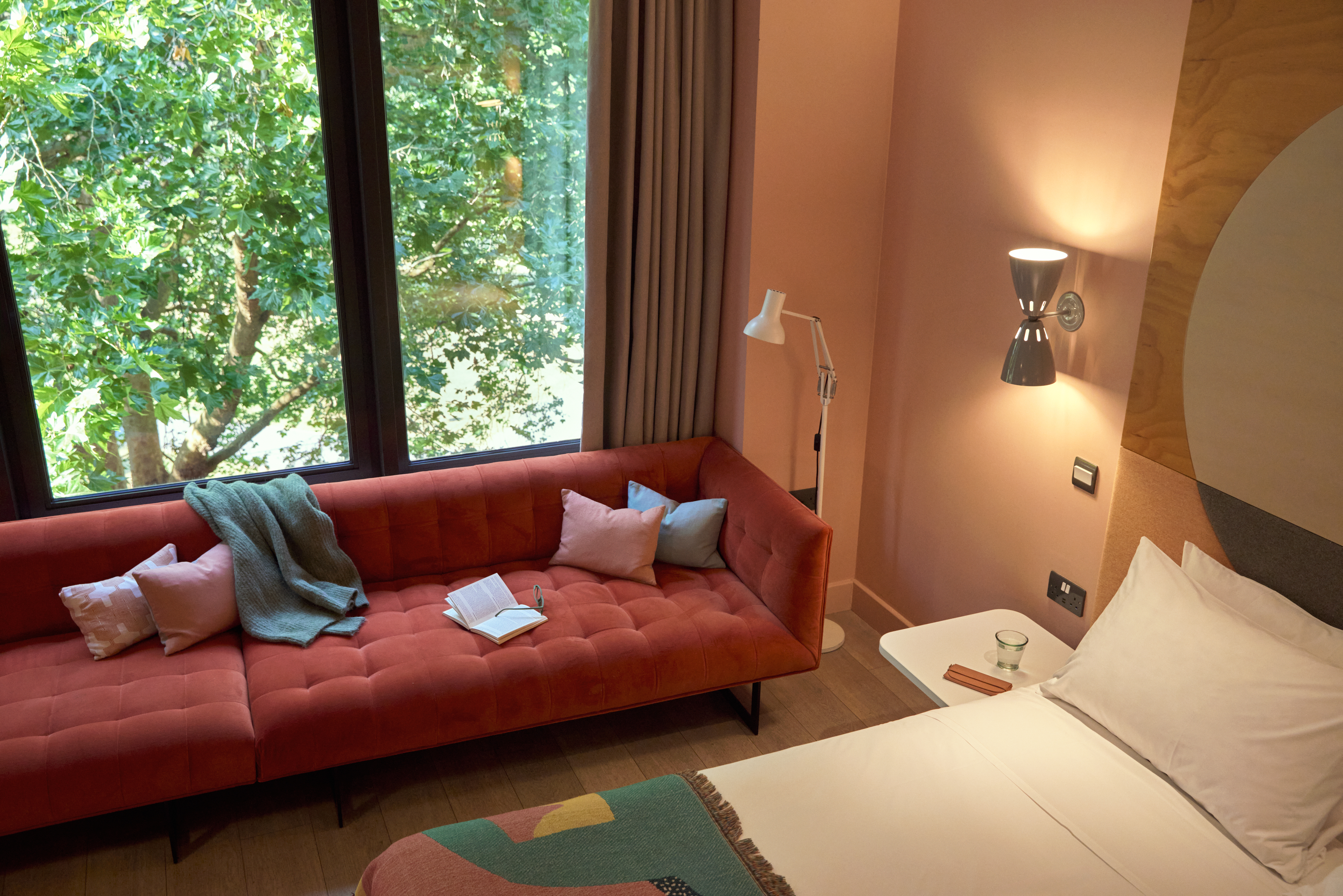 vibrant orange sofa near a huge window glass at Second Nature Southampton Hometel